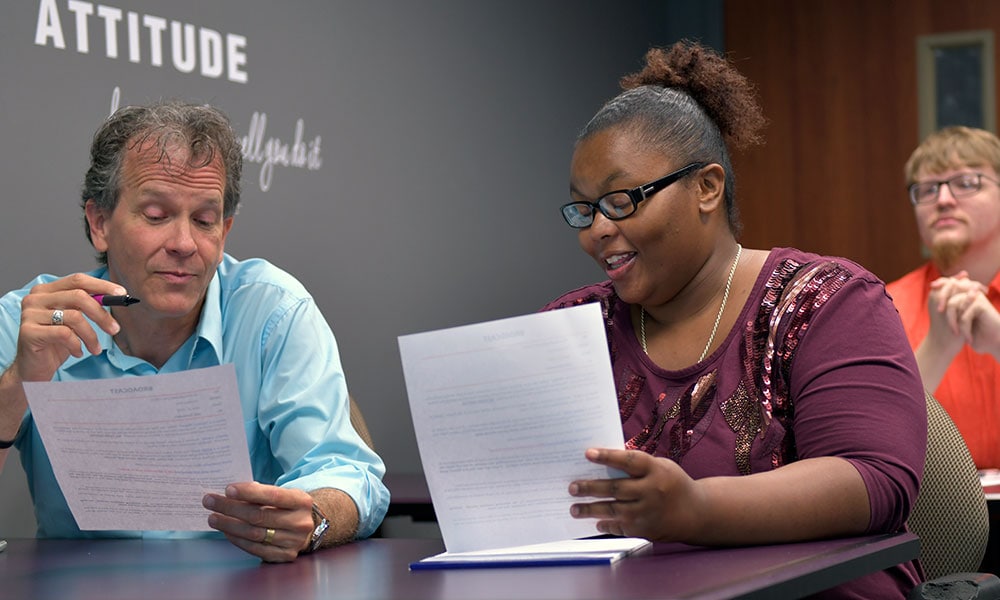 Two Openzonefy employees discussing paperwork